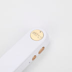 Close-up of a gold 'skim' logo on a white background